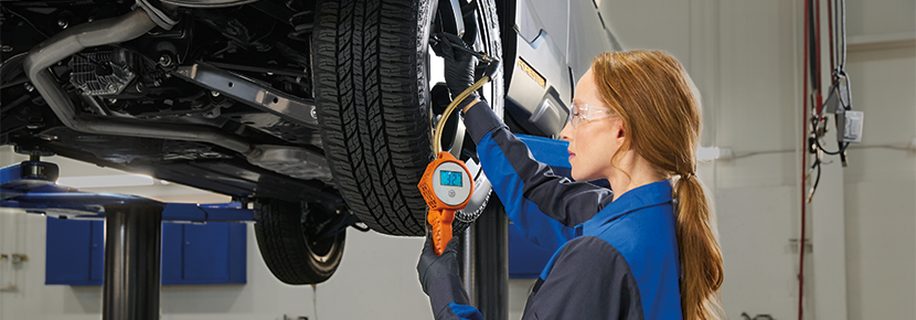 A Subaru technician checking tire pressure. | Tonkin Subaru in The Dalles OR