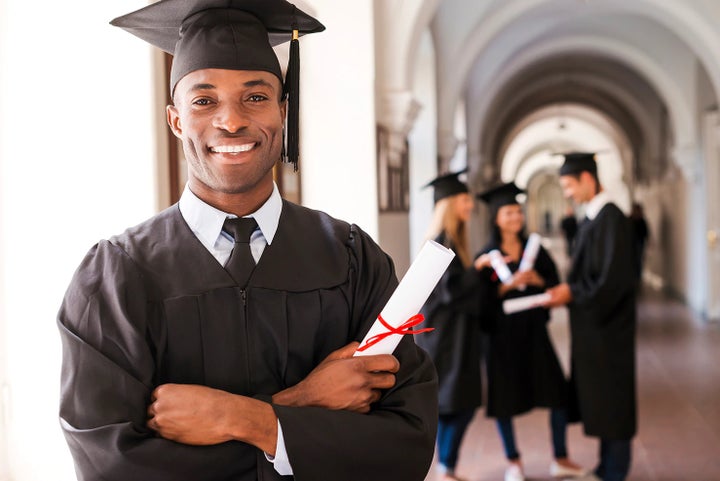 college graduate holding his diploma | Tonkin Subaru in The Dalles OR