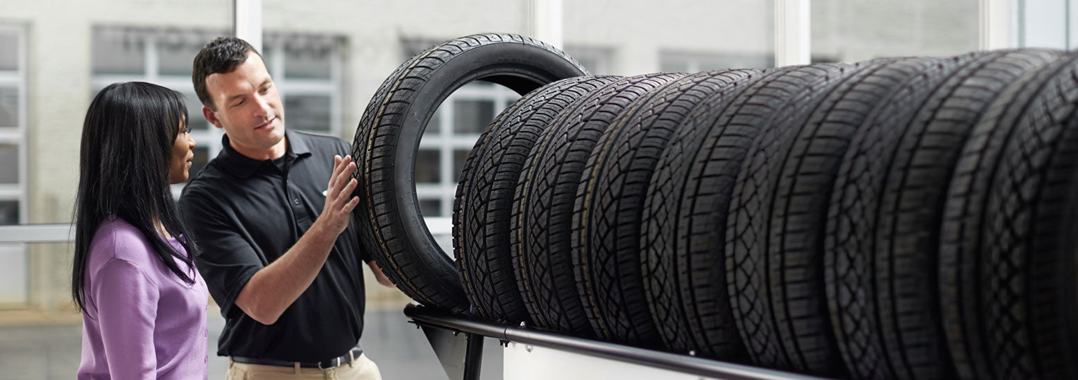 Subaru service representative showing customer a tire. | Tonkin Subaru in The Dalles OR