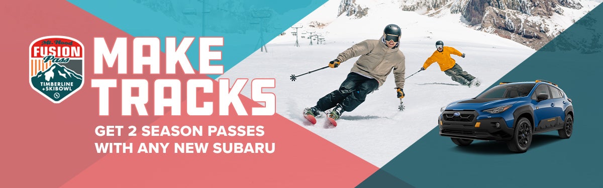 2025 Outback Wilderness parked in front of two people skiing down a mountain